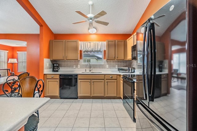 kitchen with tasteful backsplash, sink, light tile patterned floors, and black appliances