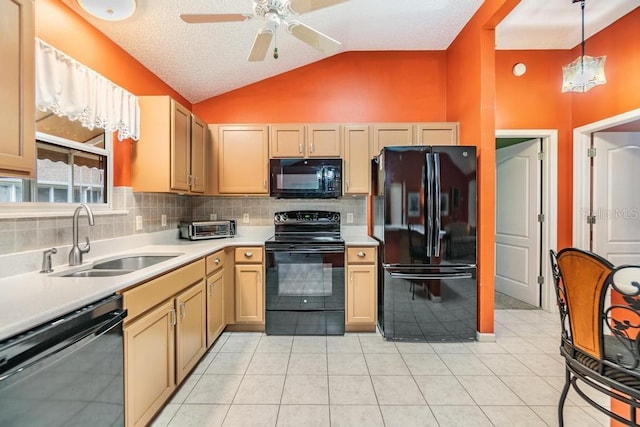 kitchen with lofted ceiling, sink, tasteful backsplash, decorative light fixtures, and black appliances