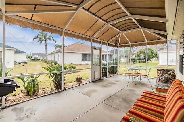 sunroom / solarium featuring lofted ceiling