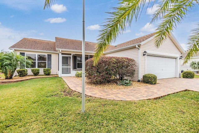 single story home featuring a garage and a front yard