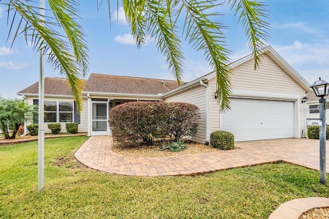 single story home with a garage and a front yard