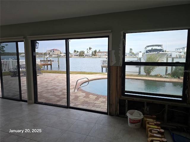 entryway with a water view and tile patterned floors