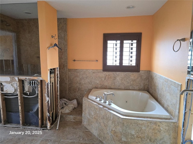 bathroom with tiled bath