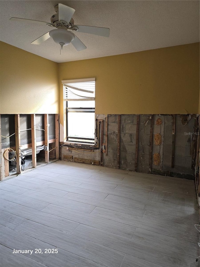 empty room with ceiling fan and hardwood / wood-style floors