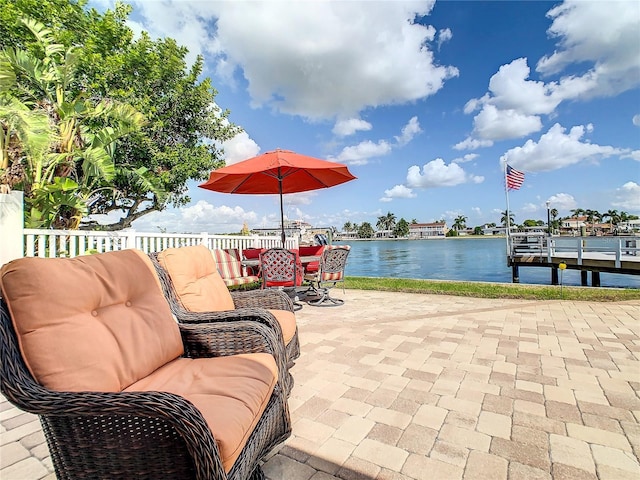 view of patio featuring a water view and a boat dock