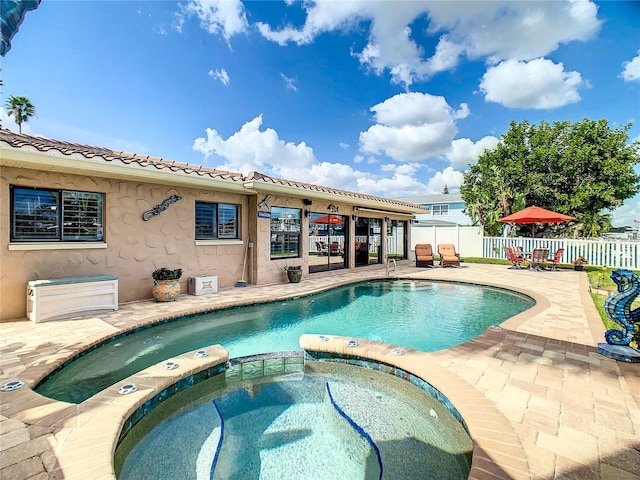 view of pool featuring an in ground hot tub and a patio