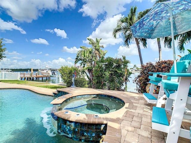 view of swimming pool featuring an in ground hot tub and a water view