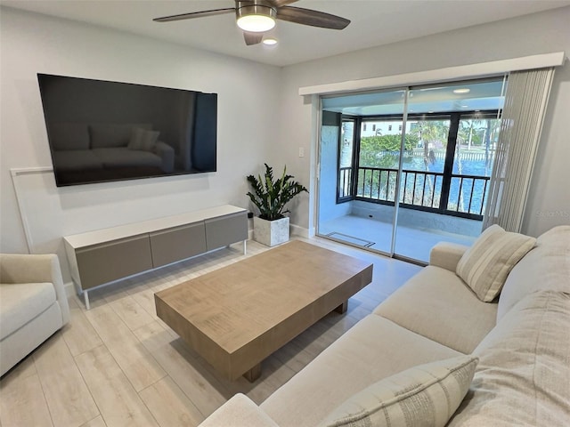 living room featuring ceiling fan and light wood-type flooring