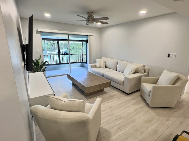 living room with ceiling fan and light hardwood / wood-style floors