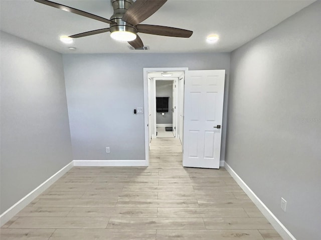 spare room featuring ceiling fan and light wood-type flooring