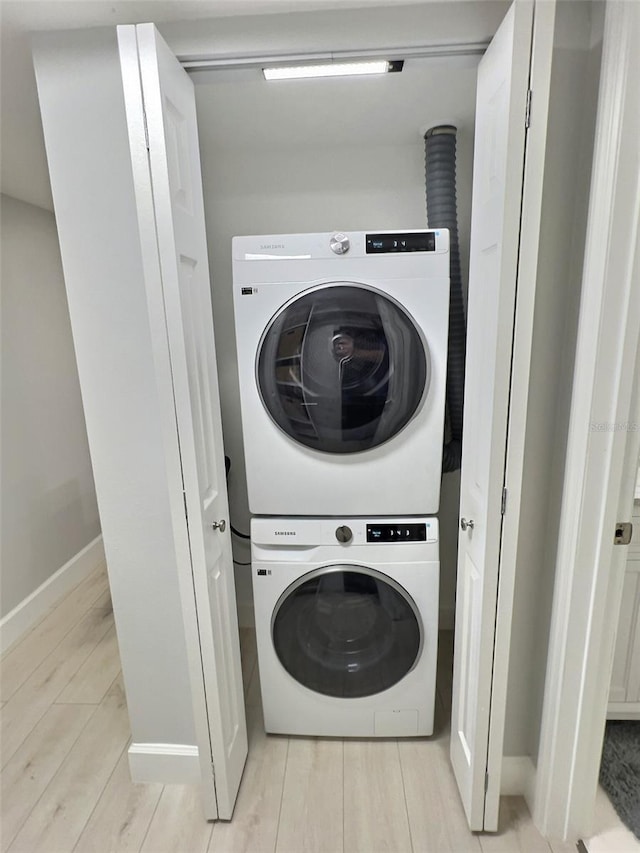 washroom featuring stacked washing maching and dryer