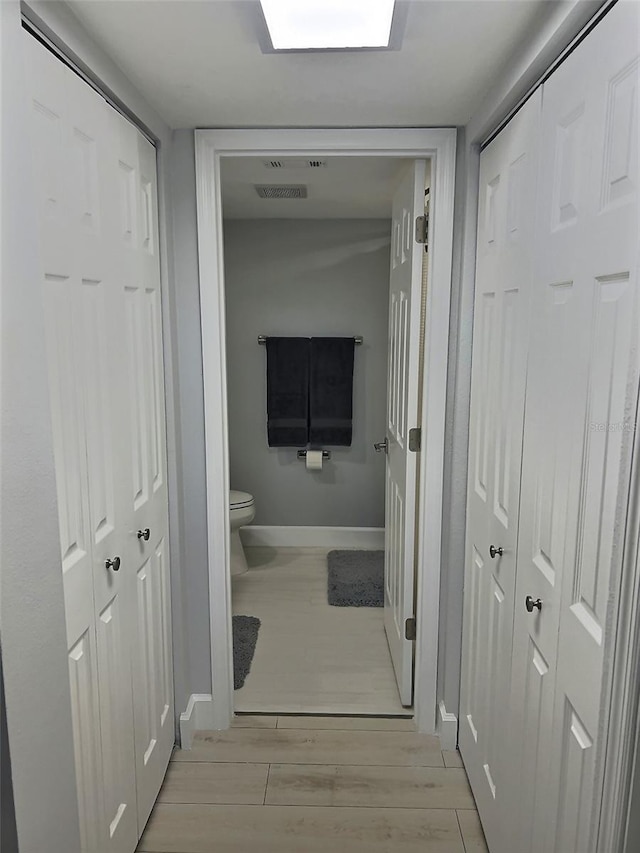 corridor featuring light hardwood / wood-style floors