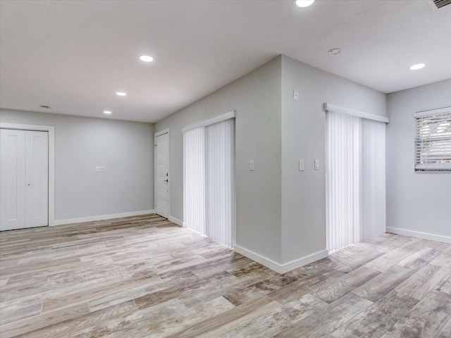 empty room with light hardwood / wood-style flooring