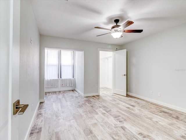 spare room featuring light hardwood / wood-style floors and ceiling fan