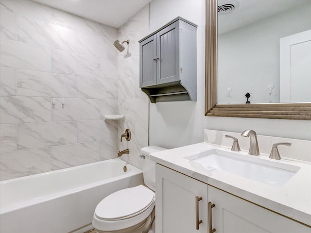 full bathroom featuring tiled shower / bath combo, vanity, and toilet