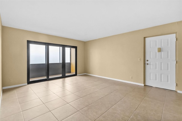 spare room featuring light tile patterned flooring