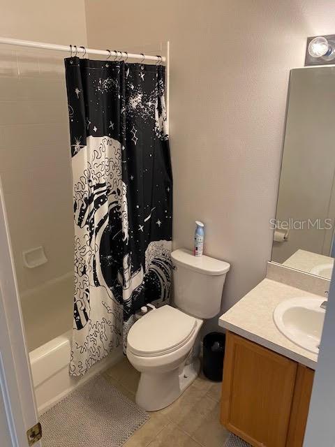 full bathroom featuring vanity, toilet, shower / tub combo, and tile patterned floors