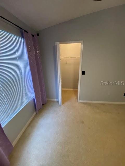 unfurnished bedroom featuring a closet and a spacious closet