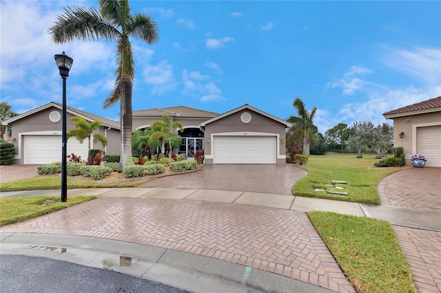 view of front of home with a garage and a front yard