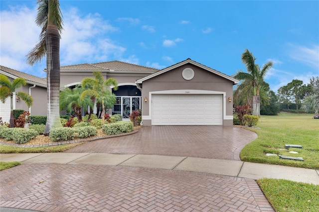 view of front of home with a garage and a front lawn