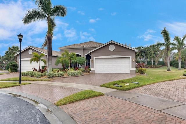 view of front of home featuring a garage and a front yard