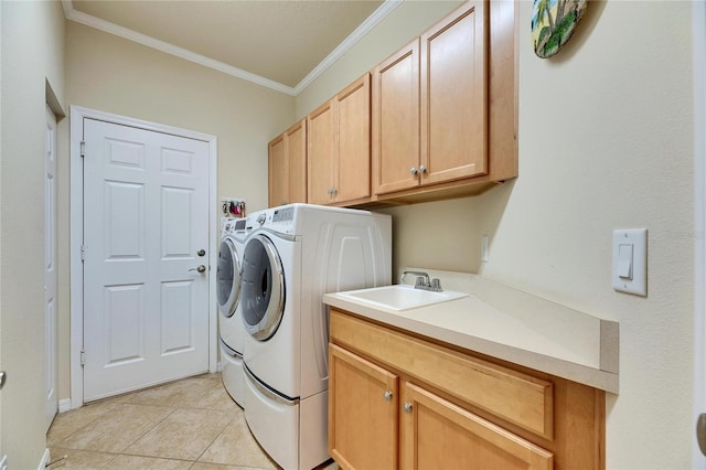 laundry room with light tile patterned flooring, washing machine and clothes dryer, sink, cabinets, and ornamental molding