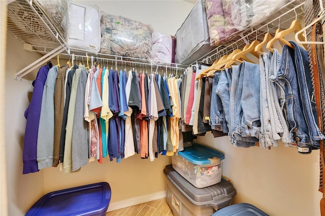 walk in closet with hardwood / wood-style floors