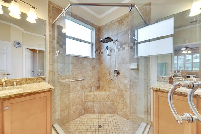 bathroom featuring crown molding, ceiling fan, vanity, and an enclosed shower