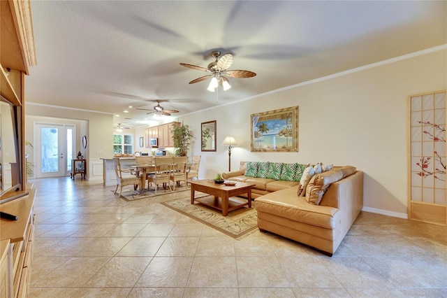 living room featuring ceiling fan, ornamental molding, and light tile patterned floors