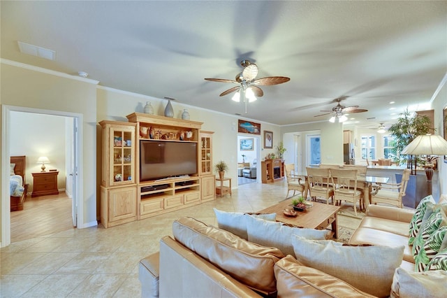 tiled living room with ornamental molding and ceiling fan