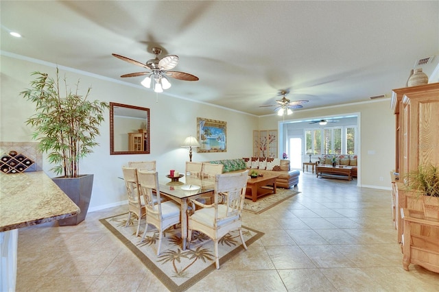 dining area featuring crown molding and light tile patterned floors