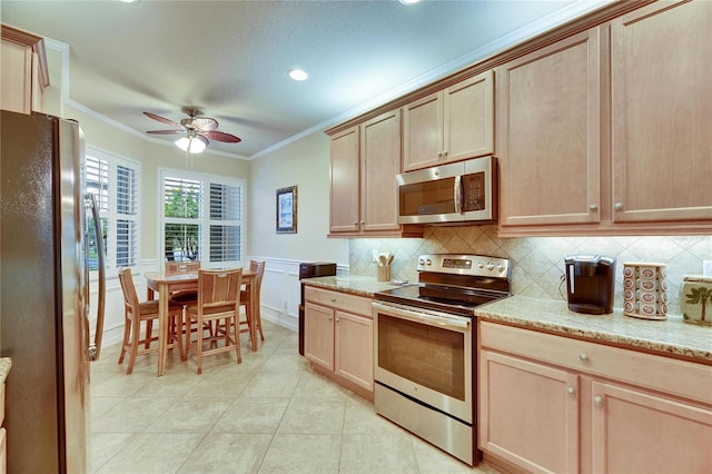 kitchen with crown molding, stainless steel appliances, and light brown cabinets