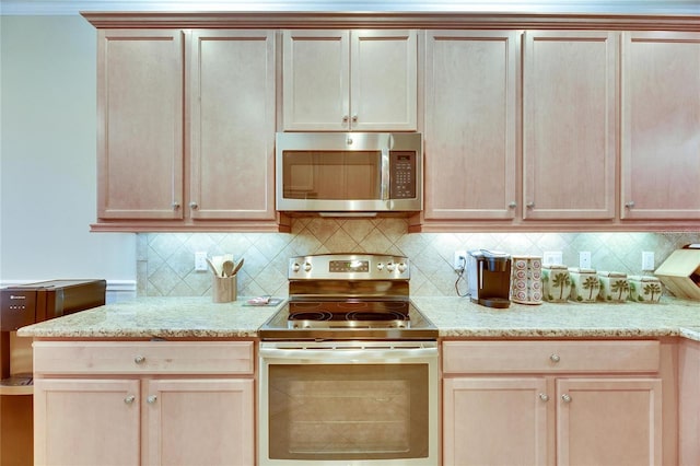 kitchen with appliances with stainless steel finishes, light brown cabinets, and backsplash