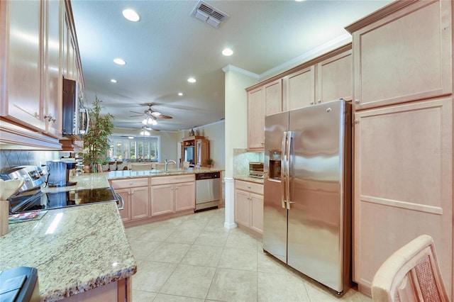 kitchen with appliances with stainless steel finishes, decorative backsplash, kitchen peninsula, crown molding, and light brown cabinets