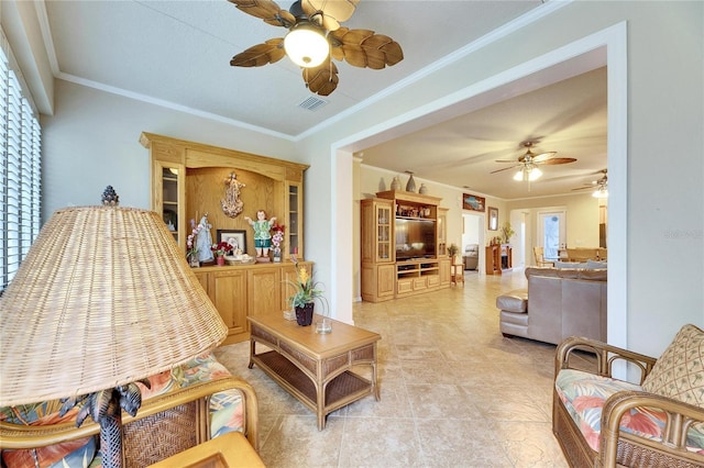 living room with light tile patterned flooring, ceiling fan, and ornamental molding