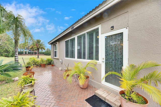 view of property exterior with a patio