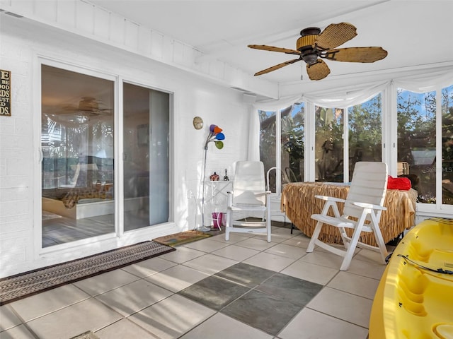 unfurnished sunroom featuring ceiling fan