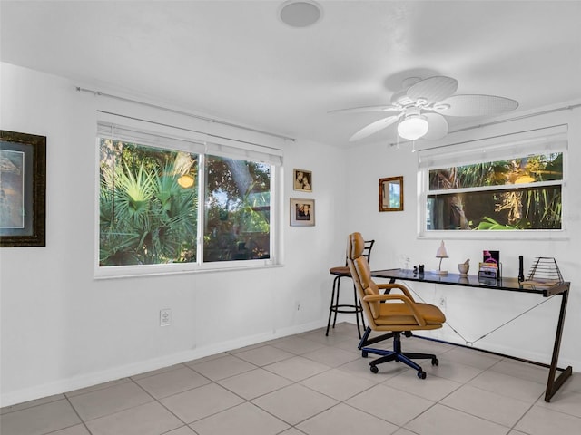 tiled office featuring ceiling fan and a healthy amount of sunlight