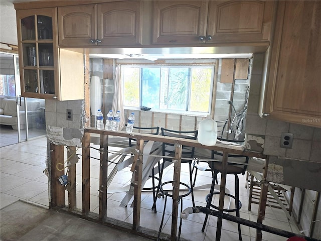 kitchen with tasteful backsplash and tile patterned flooring