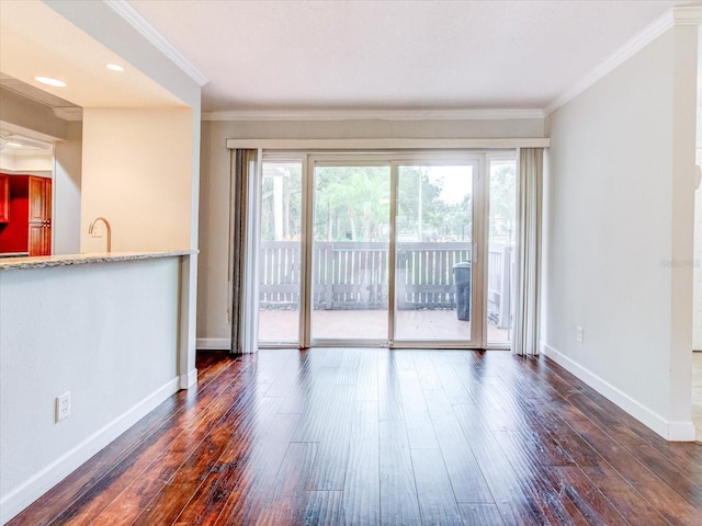 unfurnished living room with a wealth of natural light, ornamental molding, and dark hardwood / wood-style floors