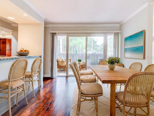 dining space featuring dark wood-type flooring, plenty of natural light, and ornamental molding