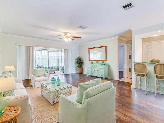 living room featuring ceiling fan, ornamental molding, and light hardwood / wood-style flooring