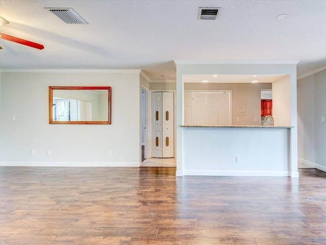 unfurnished living room with ornamental molding, hardwood / wood-style floors, and ceiling fan