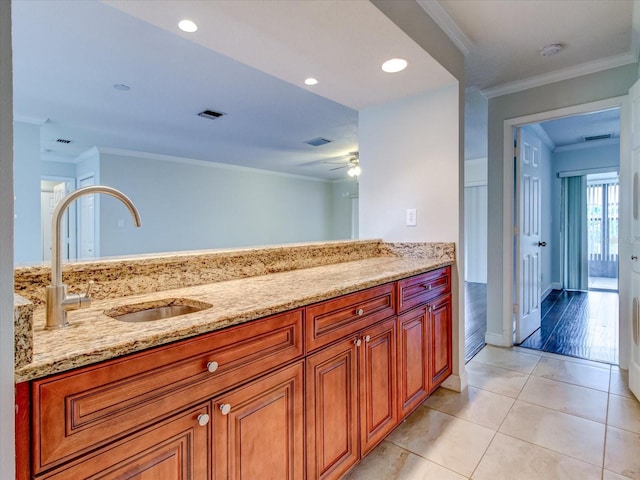 bathroom with ceiling fan, ornamental molding, tile patterned flooring, and sink