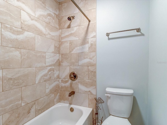 bathroom featuring tiled shower / bath and toilet