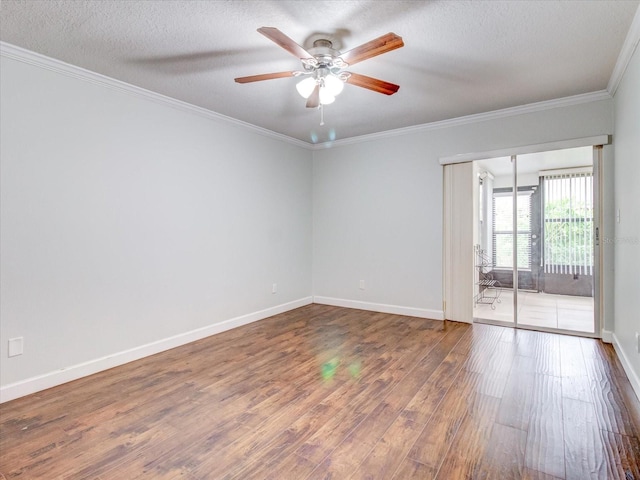 spare room featuring ceiling fan, ornamental molding, hardwood / wood-style floors, and a textured ceiling