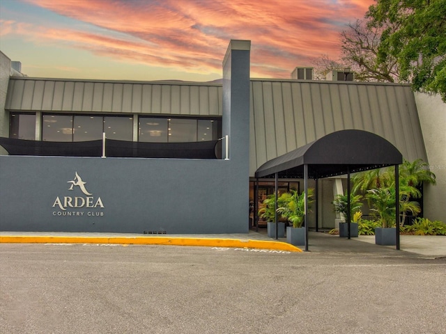 view of outdoor building at dusk