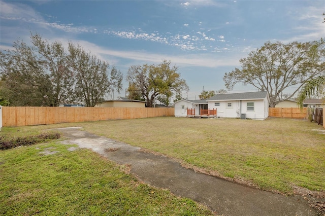 view of yard with a storage shed and a deck