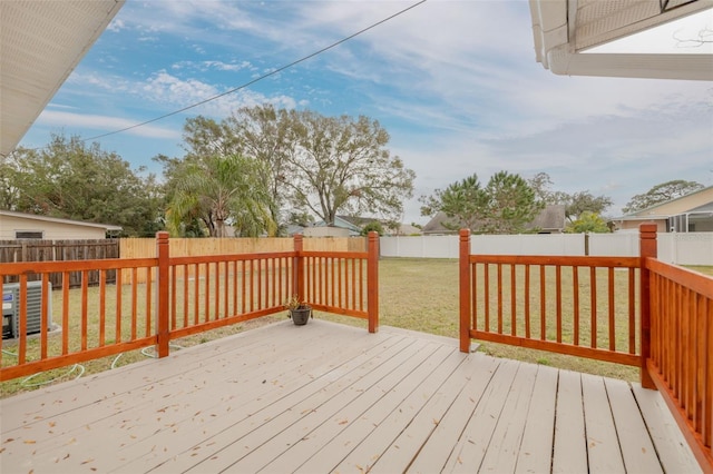 wooden terrace with central AC unit and a lawn