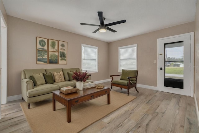 living room featuring light hardwood / wood-style flooring and ceiling fan